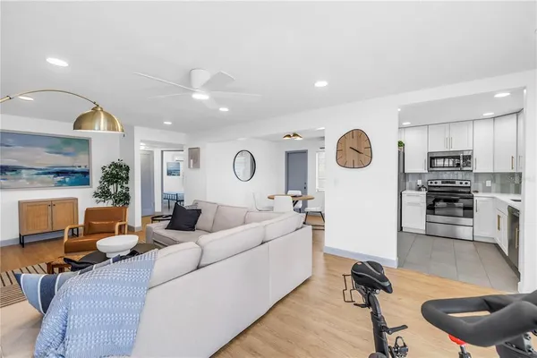 a living room with furniture and kitchen view