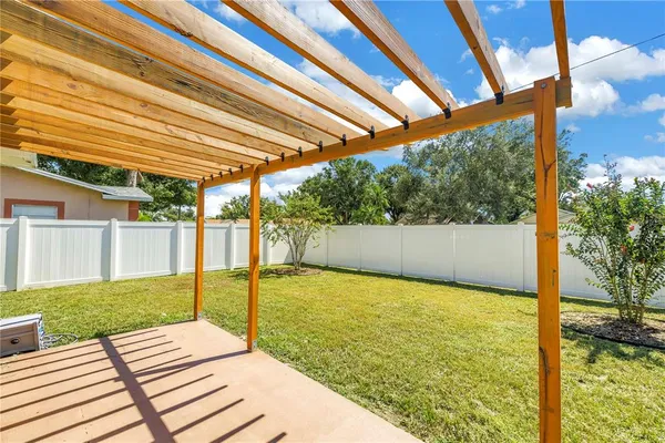 a view of backyard of house with green space