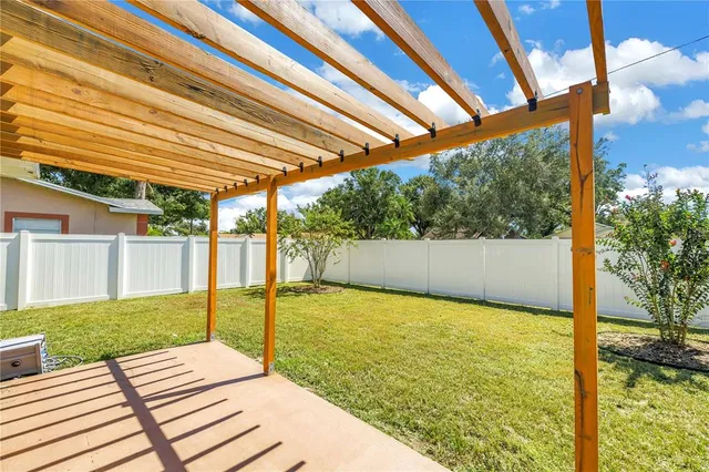 a view of backyard of house with green space