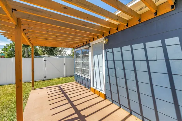 a view of a house with backyard and porch
