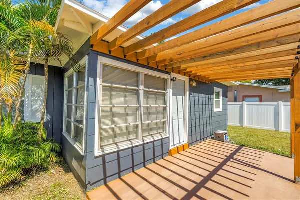 a view of an house with backyard space and balcony