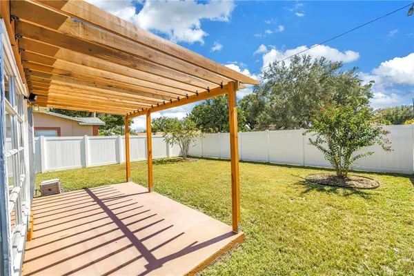 a view of a house with backyard and sitting area