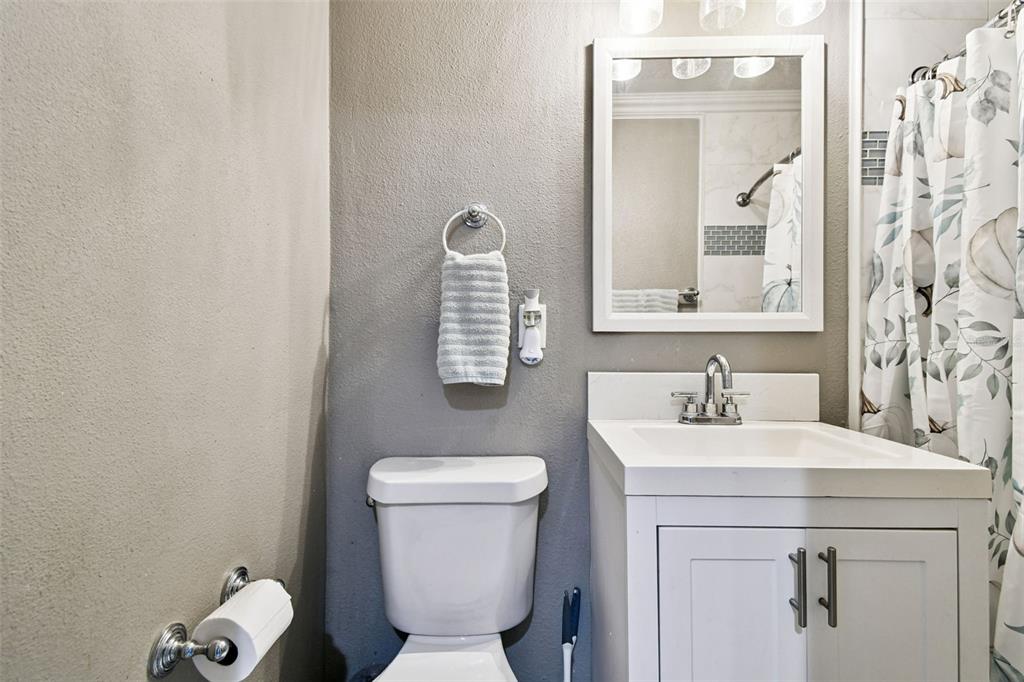5831 1st Avenue New Port Richey, FL 34652 - Photo 15 of 22 a bathroom with a toilet sink and mirror