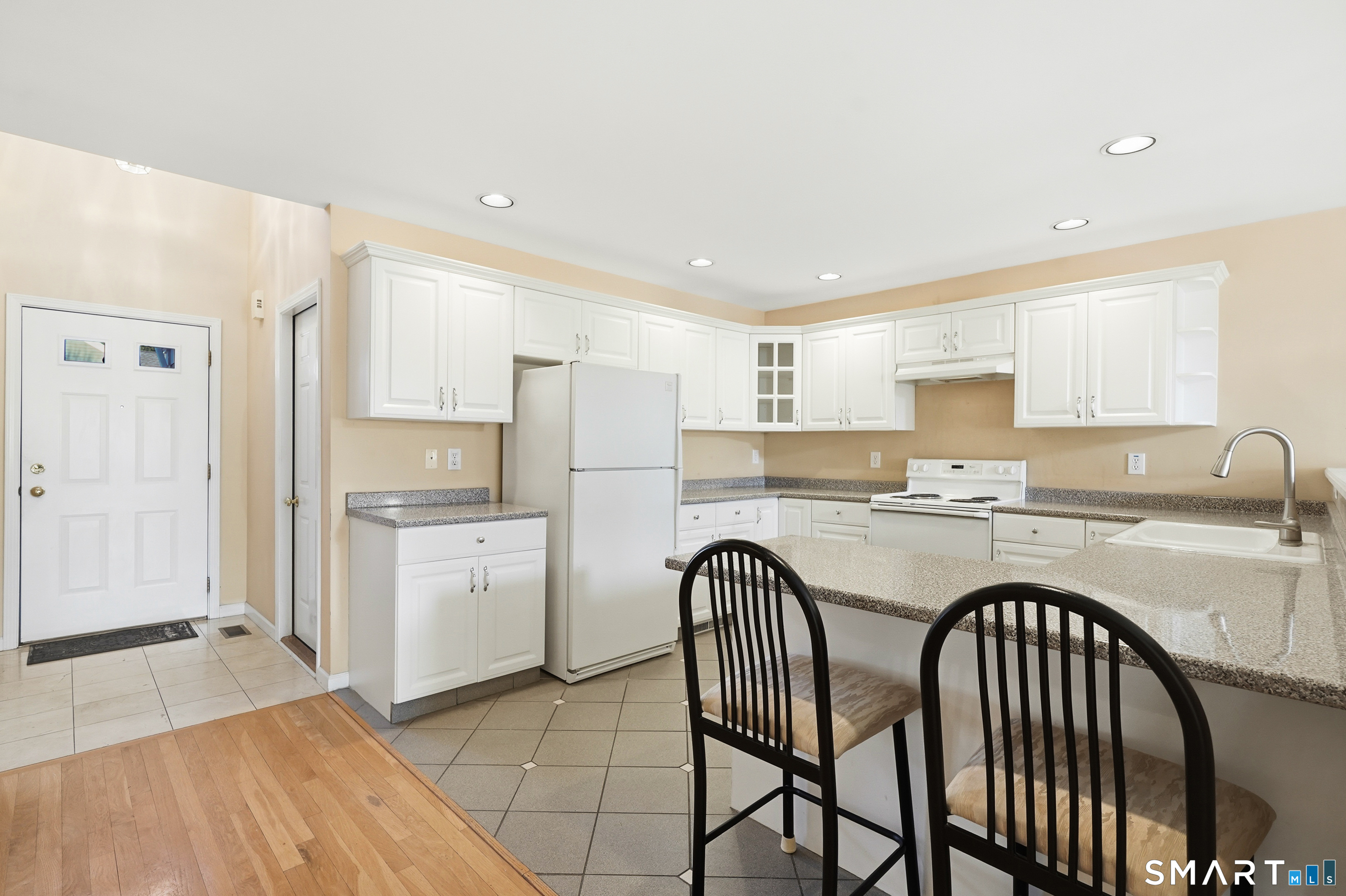 31 St George Place, Unit 31 Newtown, CT 06482 - Photo 13 of 30 a kitchen with refrigerator cabinets and a sink