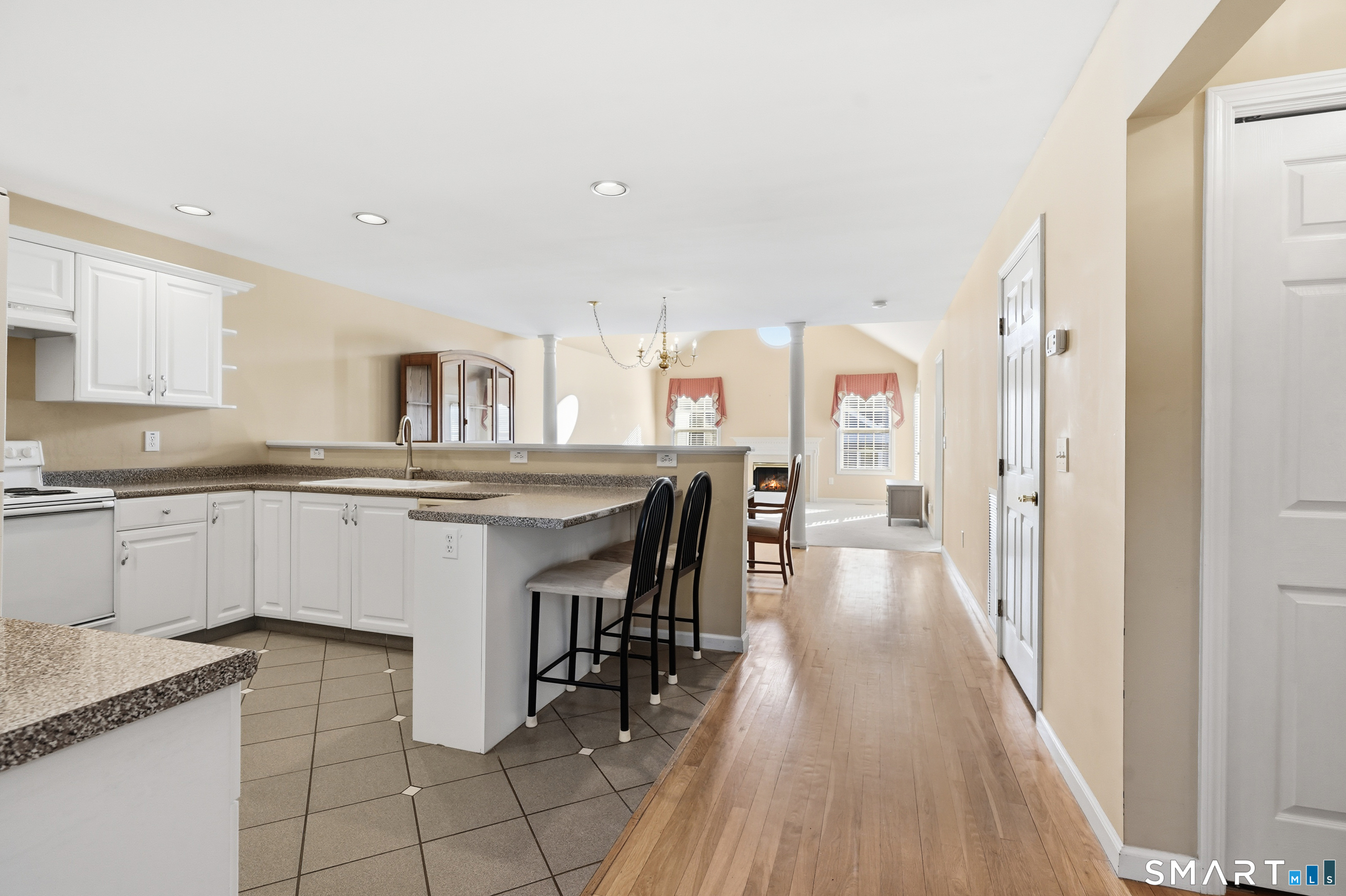 31 St George Place, Unit 31 Newtown, CT 06482 - Photo 14 of 30 a kitchen with cabinets and chairs