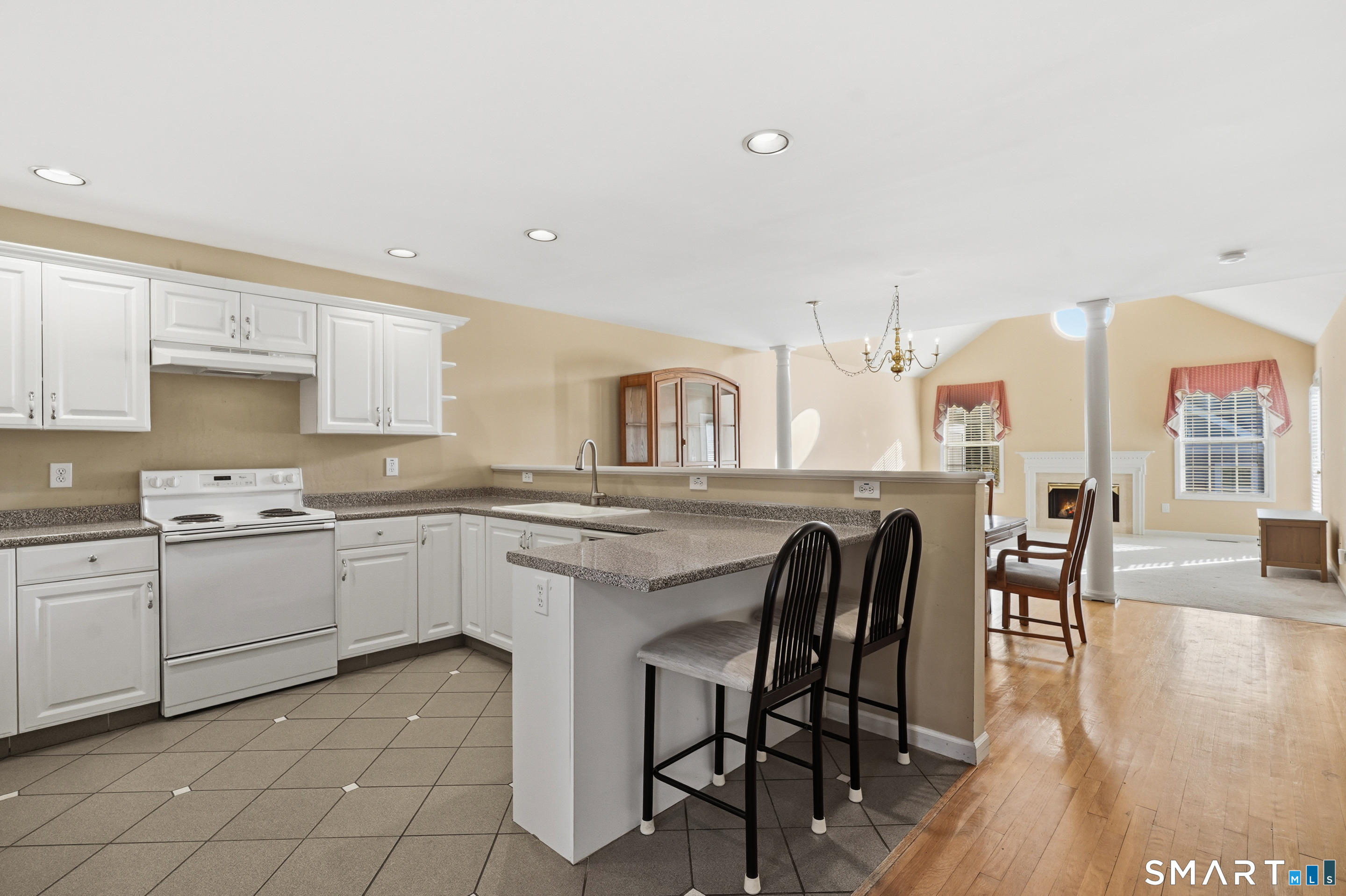 31 St George Place, Unit 31 Newtown, CT 06482 - Photo 16 of 30 a kitchen with cabinets and chairs