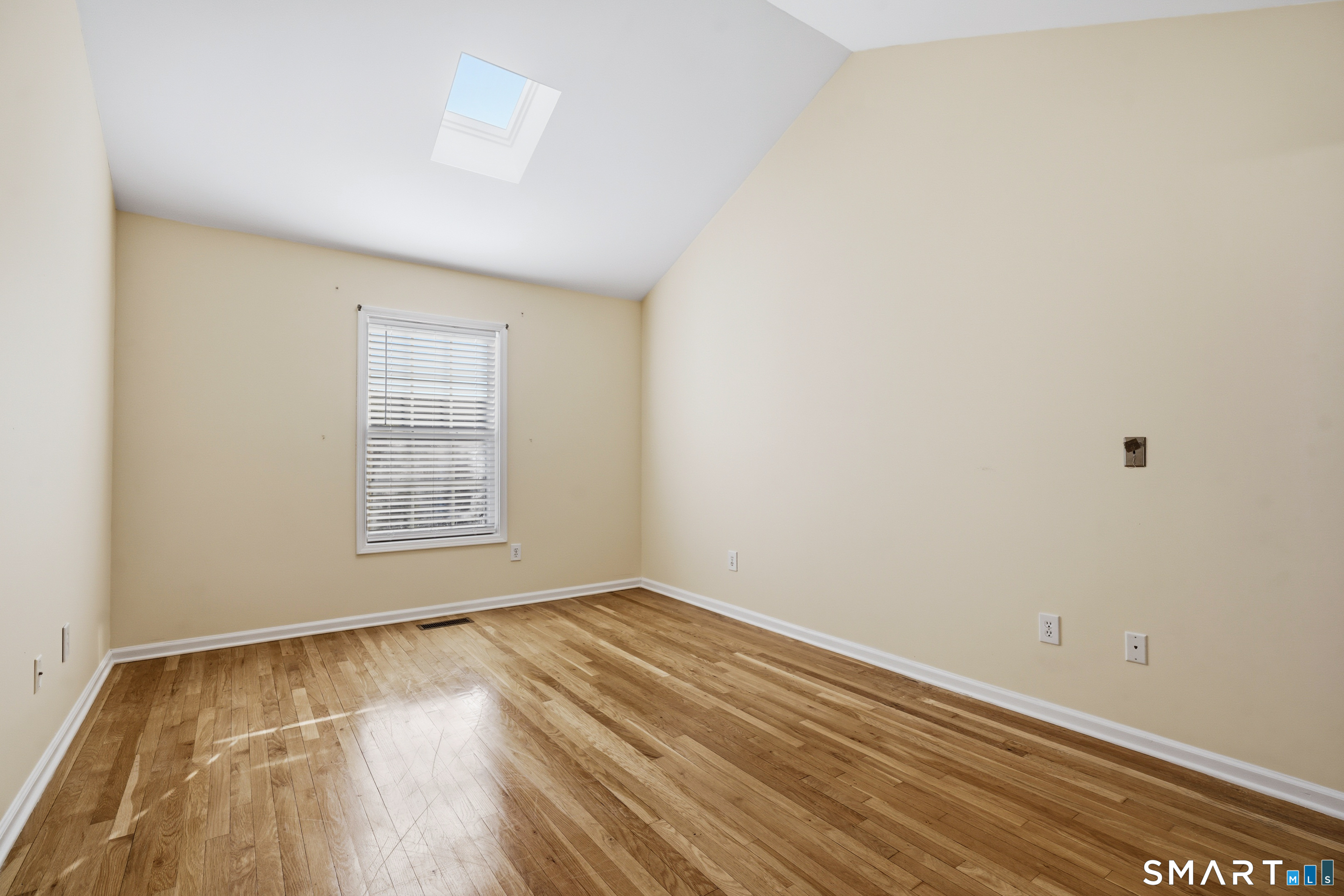 31 St George Place, Unit 31 Newtown, CT 06482 - Photo 20 of 30 an empty room with wooden floor and windows