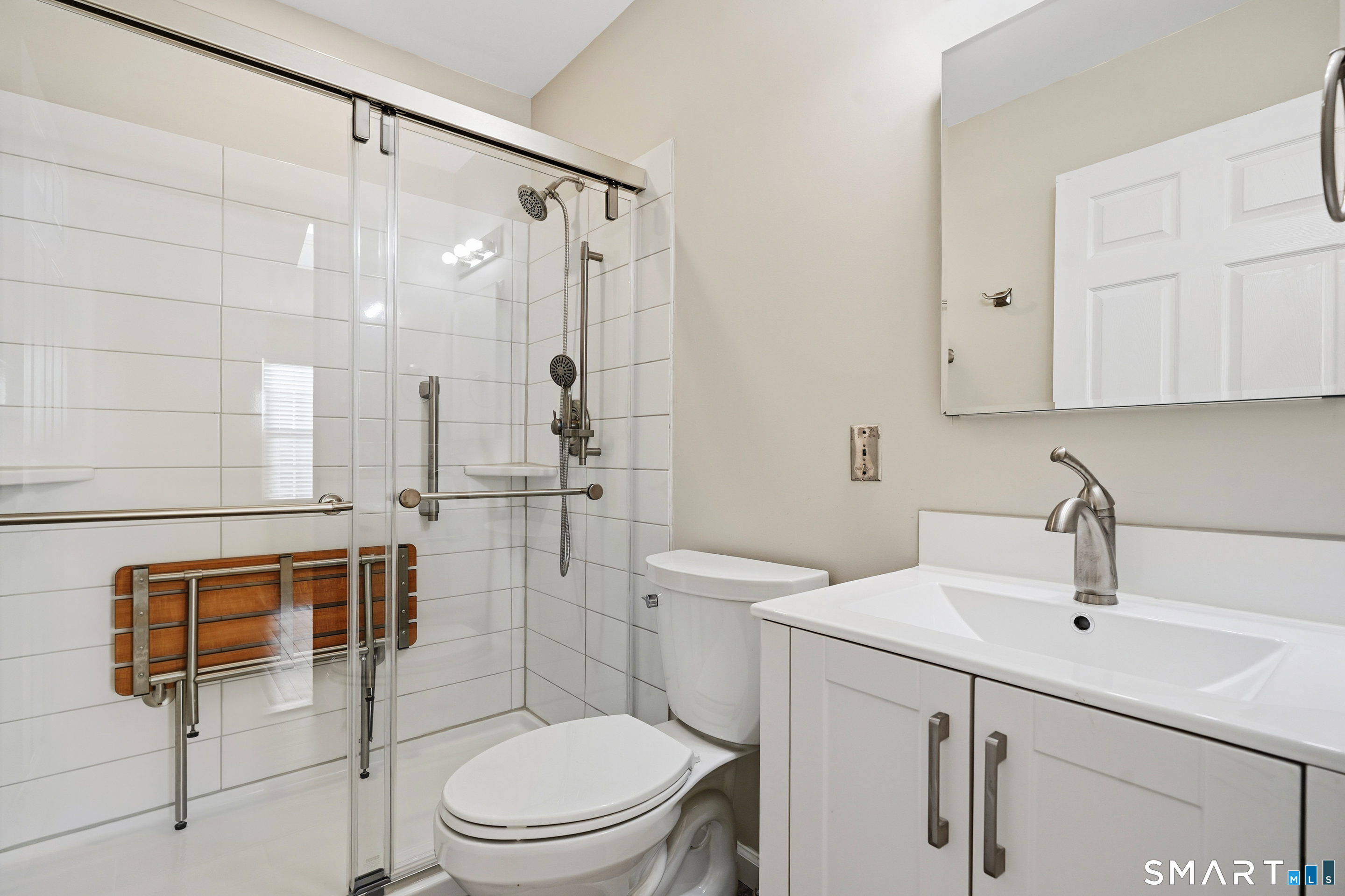 31 St George Place, Unit 31 Newtown, CT 06482 - Photo 21 of 30 a bathroom with a toilet sink shower and mirror