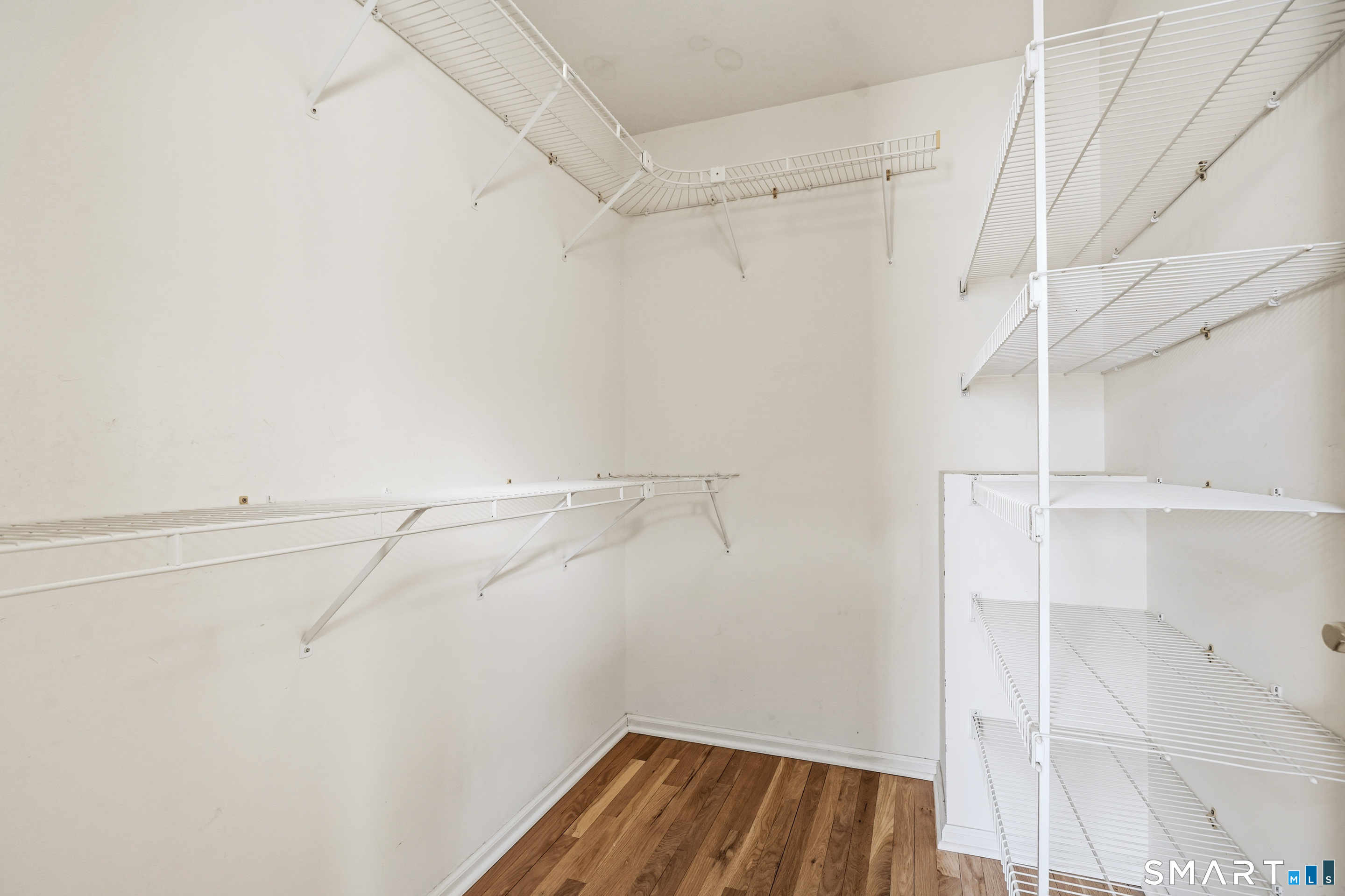 31 St George Place, Unit 31 Newtown, CT 06482 - Photo 22 of 30 a view of walk in closet with empty racks