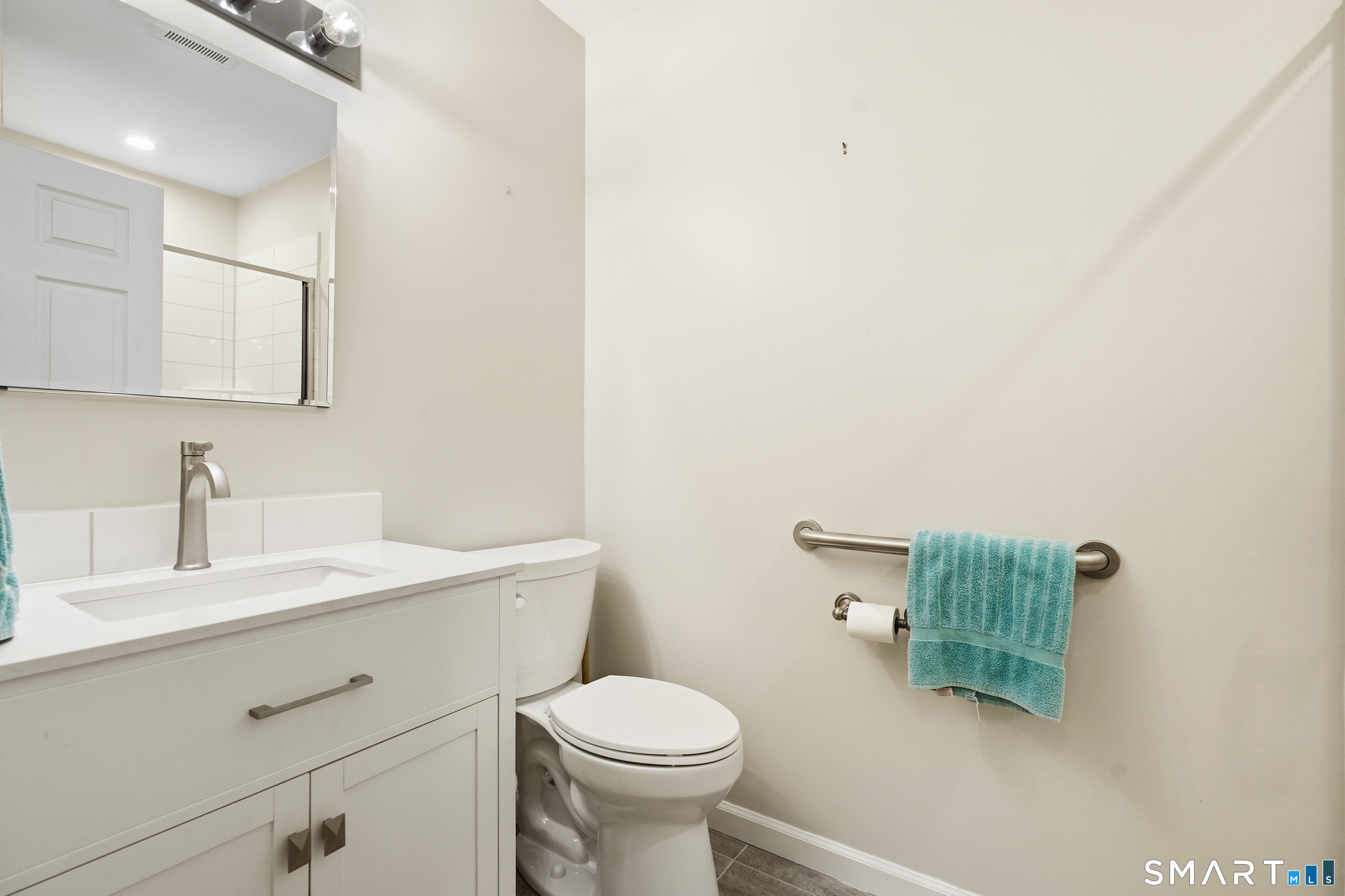 31 St George Place, Unit 31 Newtown, CT 06482 - Photo 24 of 30 a bathroom with a sink a toilet and mirror