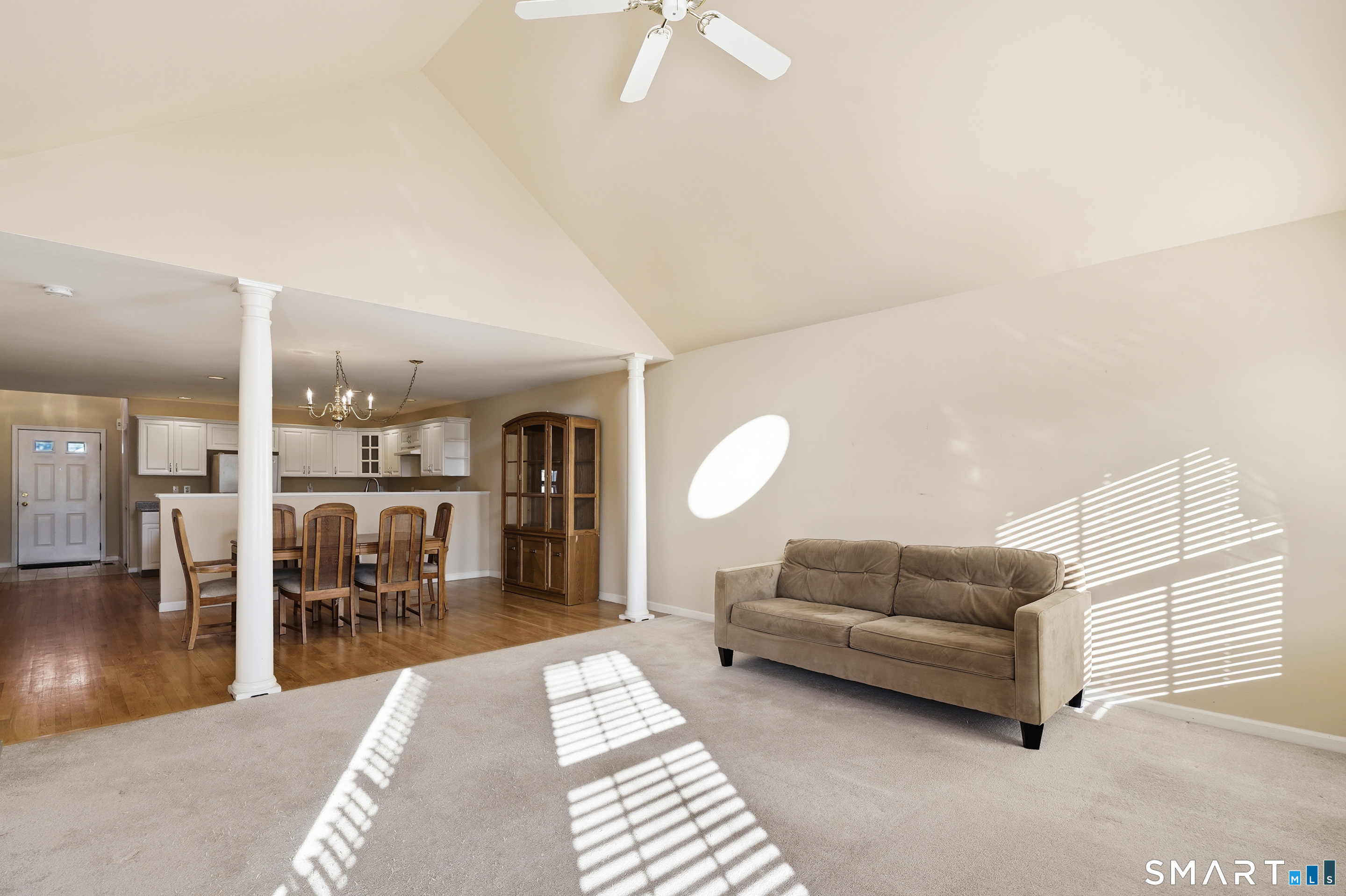 31 St George Place, Unit 31 Newtown, CT 06482 - Photo 5 of 30 a living room with furniture a rug and a chandelier