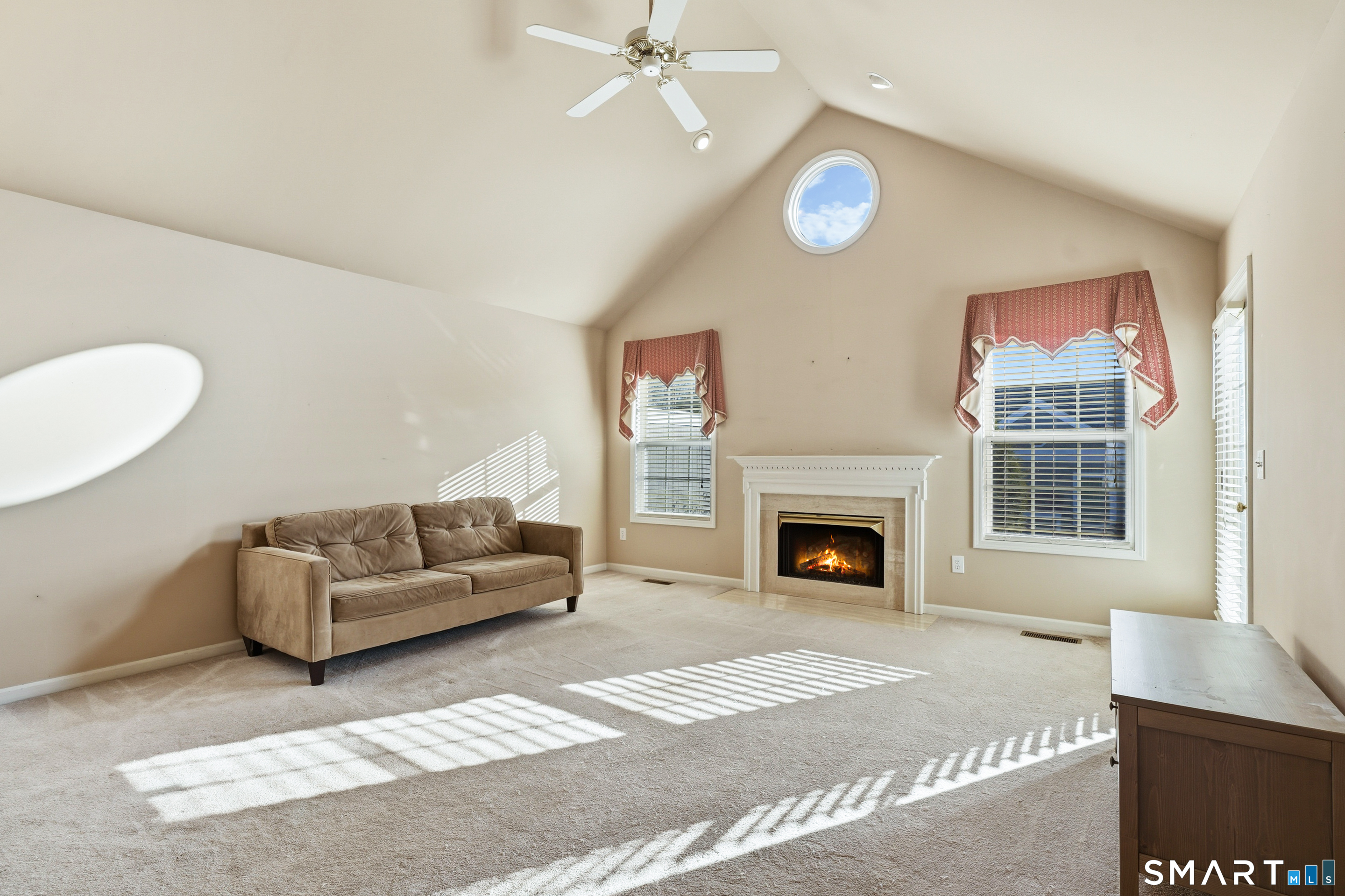 31 St George Place, Unit 31 Newtown, CT 06482 - Photo 6 of 30 a living room with furniture a fireplace and a flat screen tv