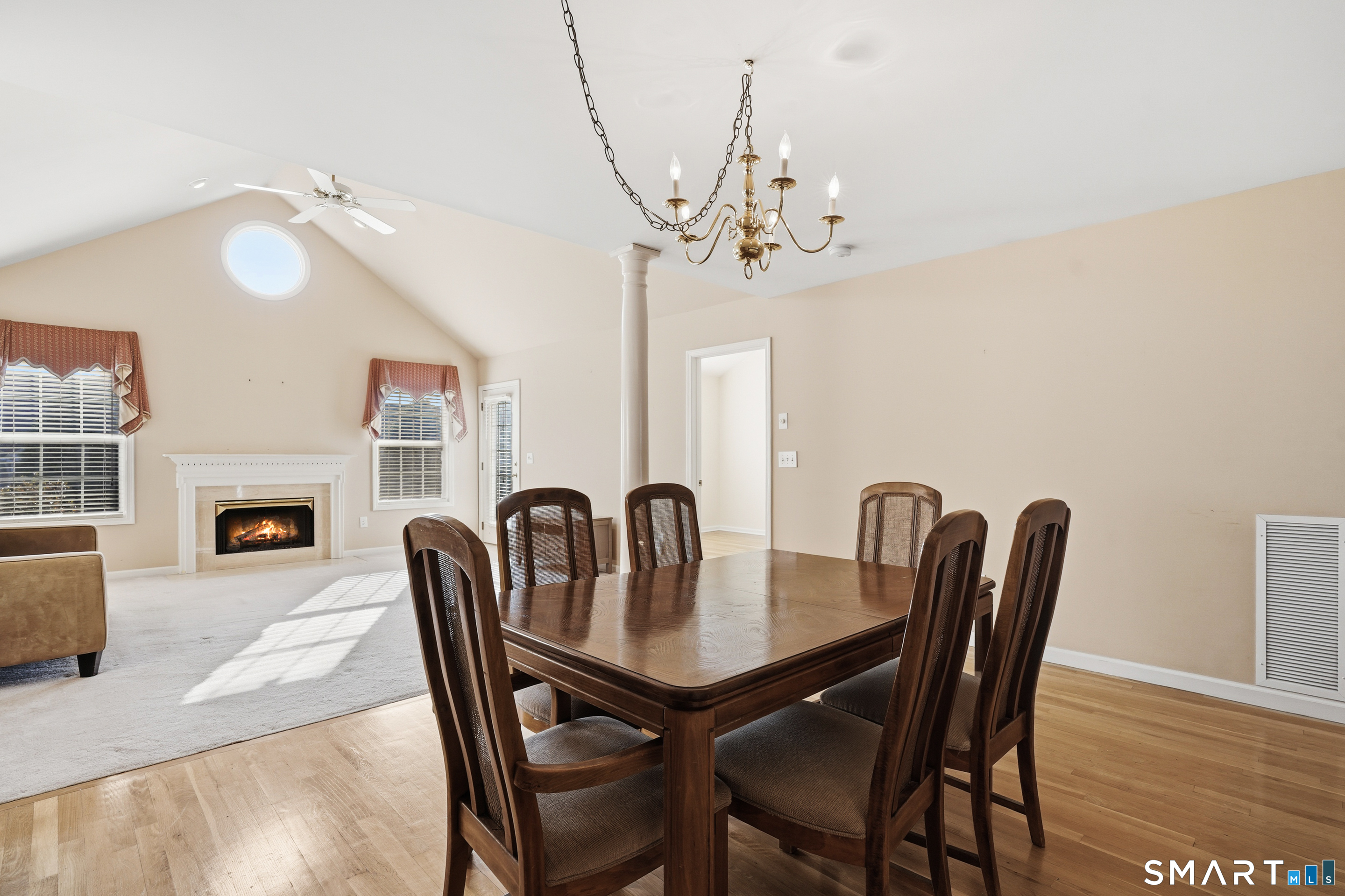 31 St George Place, Unit 31 Newtown, CT 06482 - Photo 9 of 30 a view of a dining room with furniture a fireplace and wooden floor