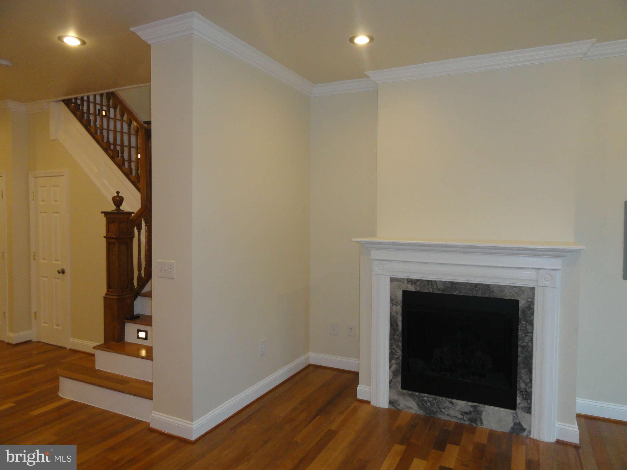 27 R Street Northeast Washington, DC 20002 - Photo 6 of 30 Living Room Fireplace Original Banister Restored