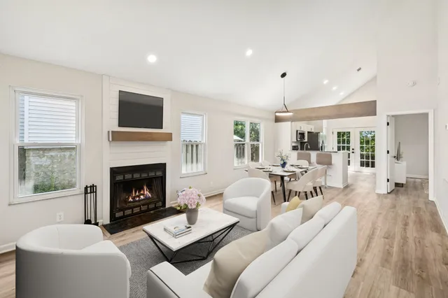 a living room with furniture a fireplace with wooden floor