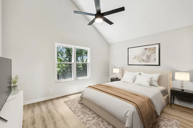 a bedroom with a large bed and a window