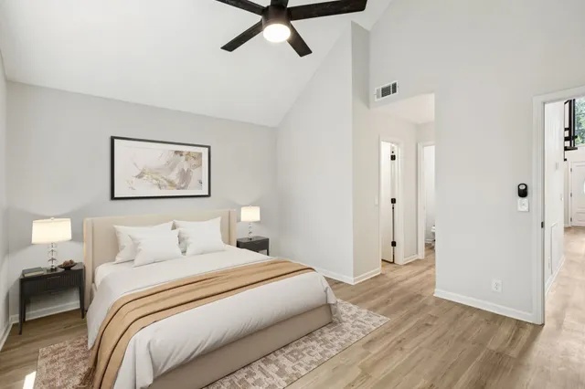 a bedroom with a bed and painting on the wall