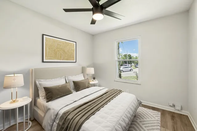 a bedroom with bed and a window