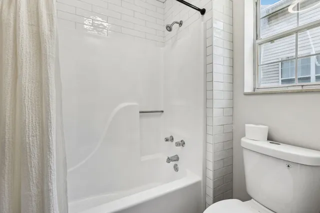 a bathroom with a shower and a toilet