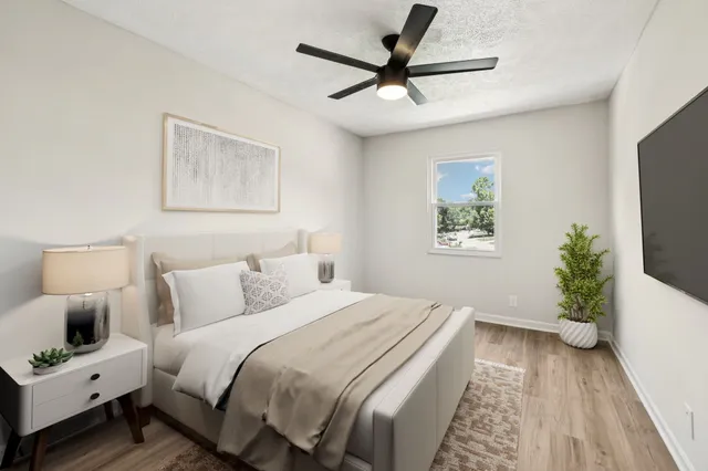 a bedroom with a bed and a flat screen tv