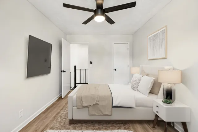 a bedroom with a bed and a flat screen tv