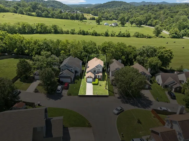 an aerial view of a house with a yard