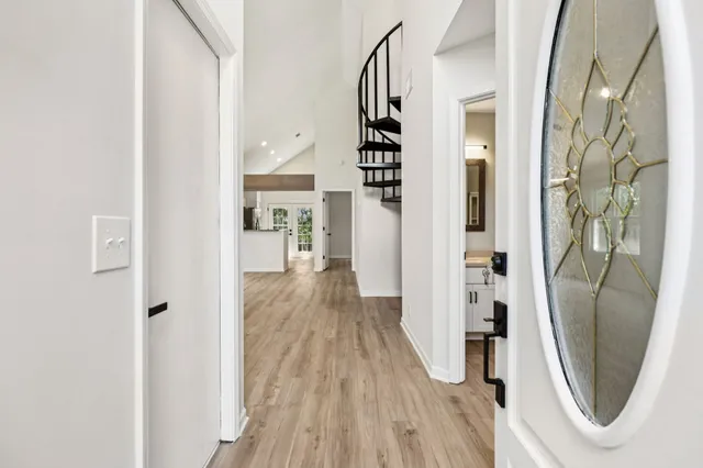 a view of a hallway with wooden floor and entryway