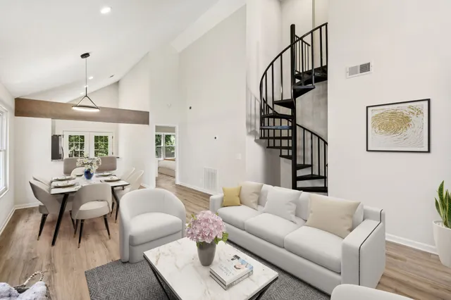 a living room with furniture and wooden floor