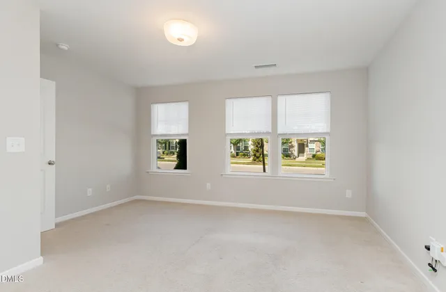 an empty room with closet and a bathroom