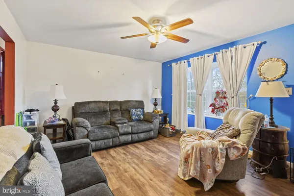 a living room with a bed furniture and a large window