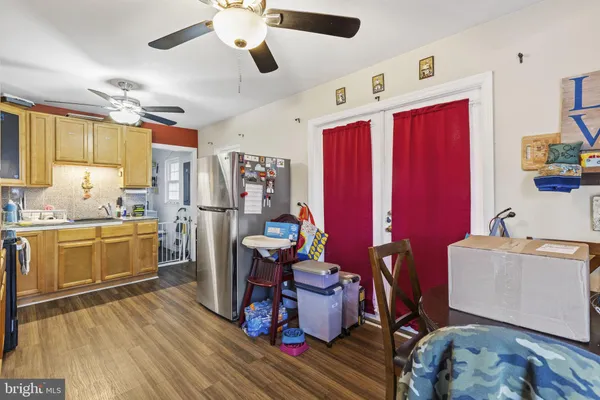 a large kitchen with a large window appliances and cabinets