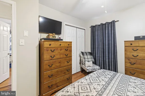 a bedroom with a bed and a television