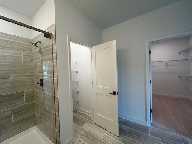 a bathroom with a glass door shower