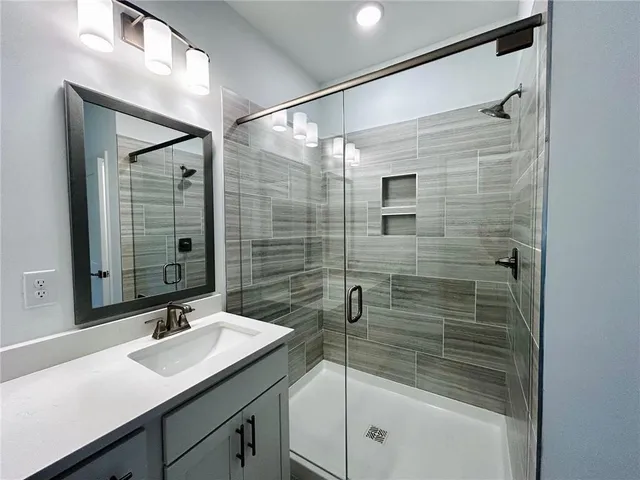 a bathroom with a shower and a sink