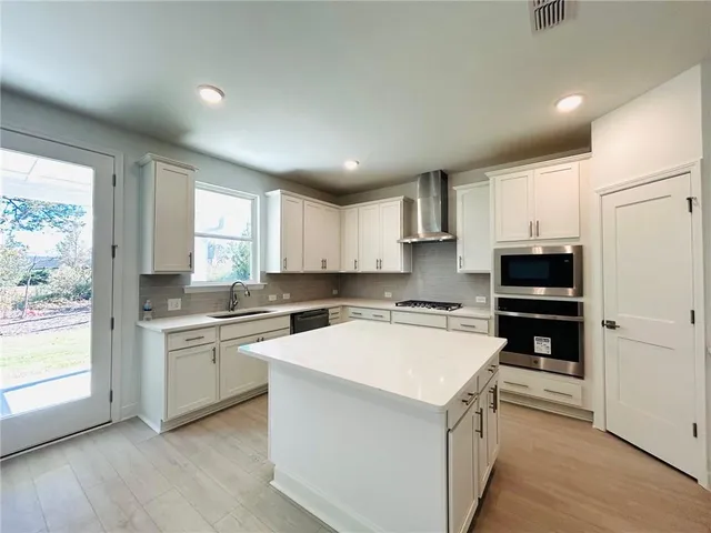a kitchen with a stove a sink and a microwave