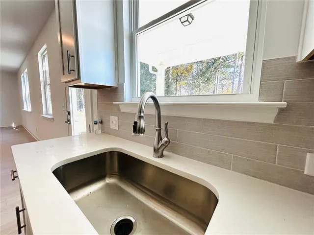 a kitchen with a sink cabinets and window