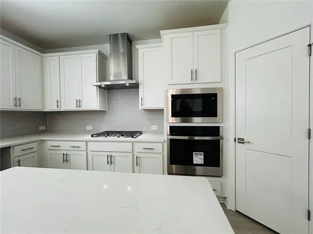 a kitchen with stainless steel appliances a stove sink and refrigerator