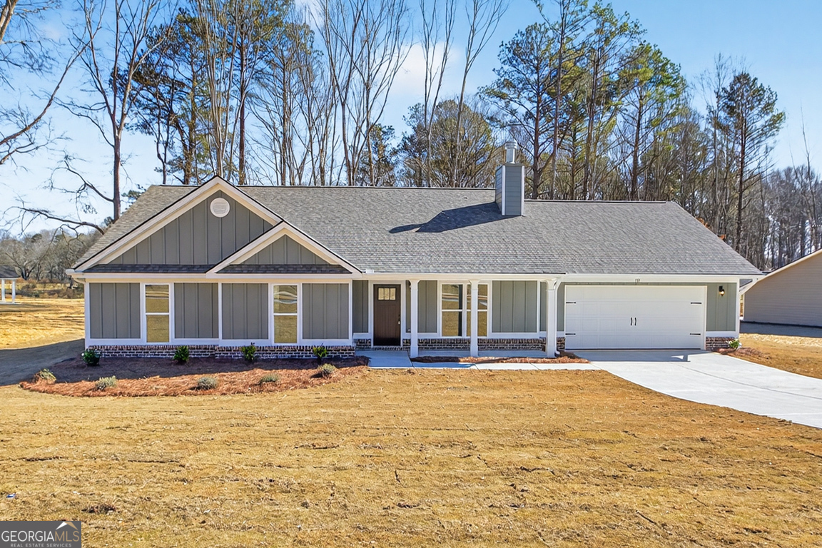 a front view of house with yard and trees around