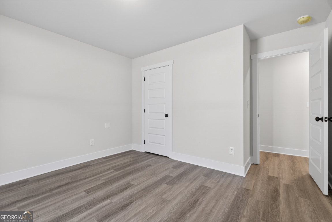 302 Mockingbird Lane, Unit 25 Winder, GA 30680 - Photo 24 of 38 a view of an empty room with wooden floor
