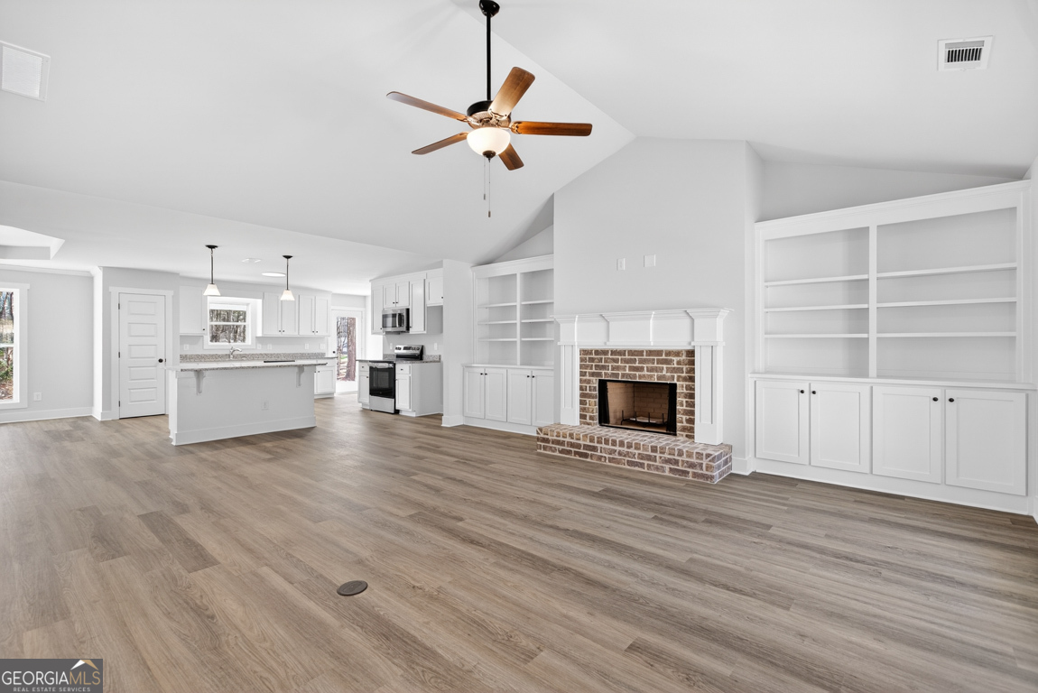 302 Mockingbird Lane, Unit 25 Winder, GA 30680 - Photo 3 of 38 a view of a kitchen with a sink and a fireplace
