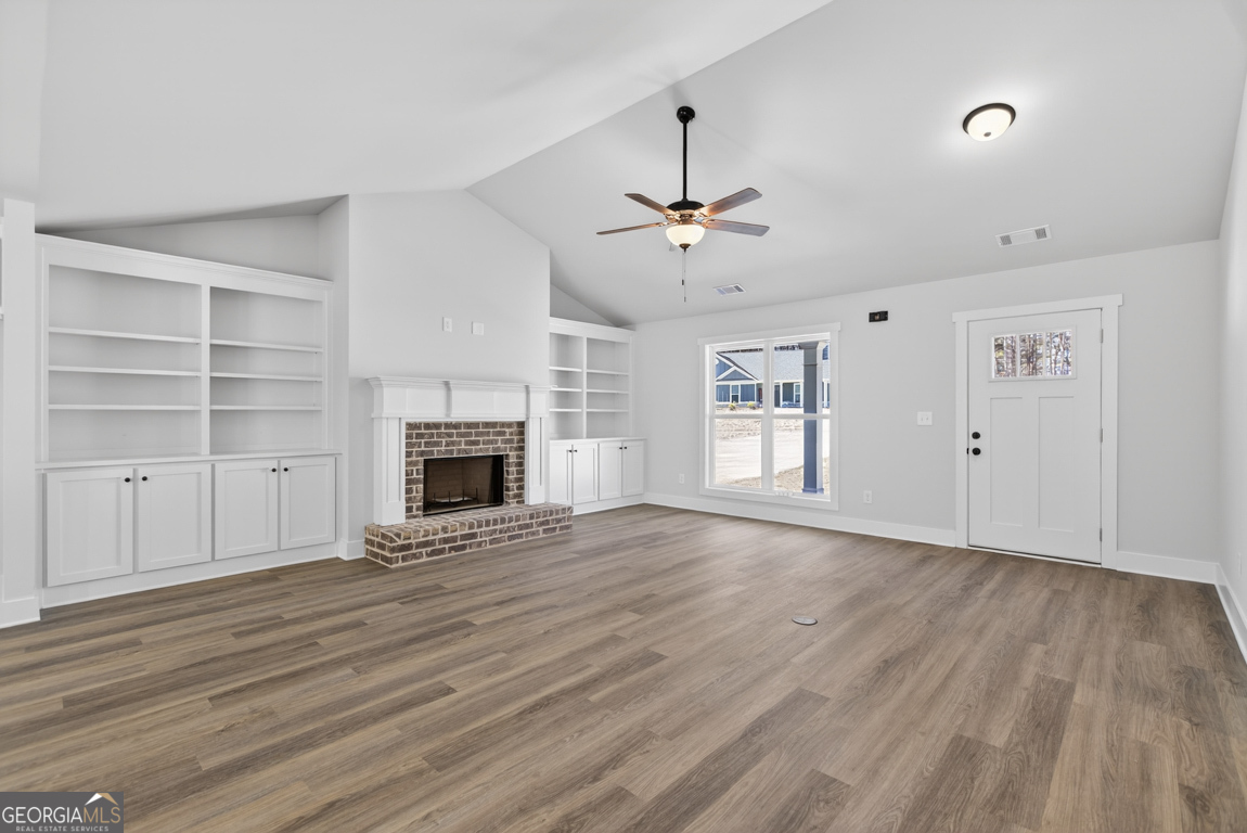 302 Mockingbird Lane, Unit 25 Winder, GA 30680 - Photo 5 of 38 a view of an empty room with a fireplace and a window