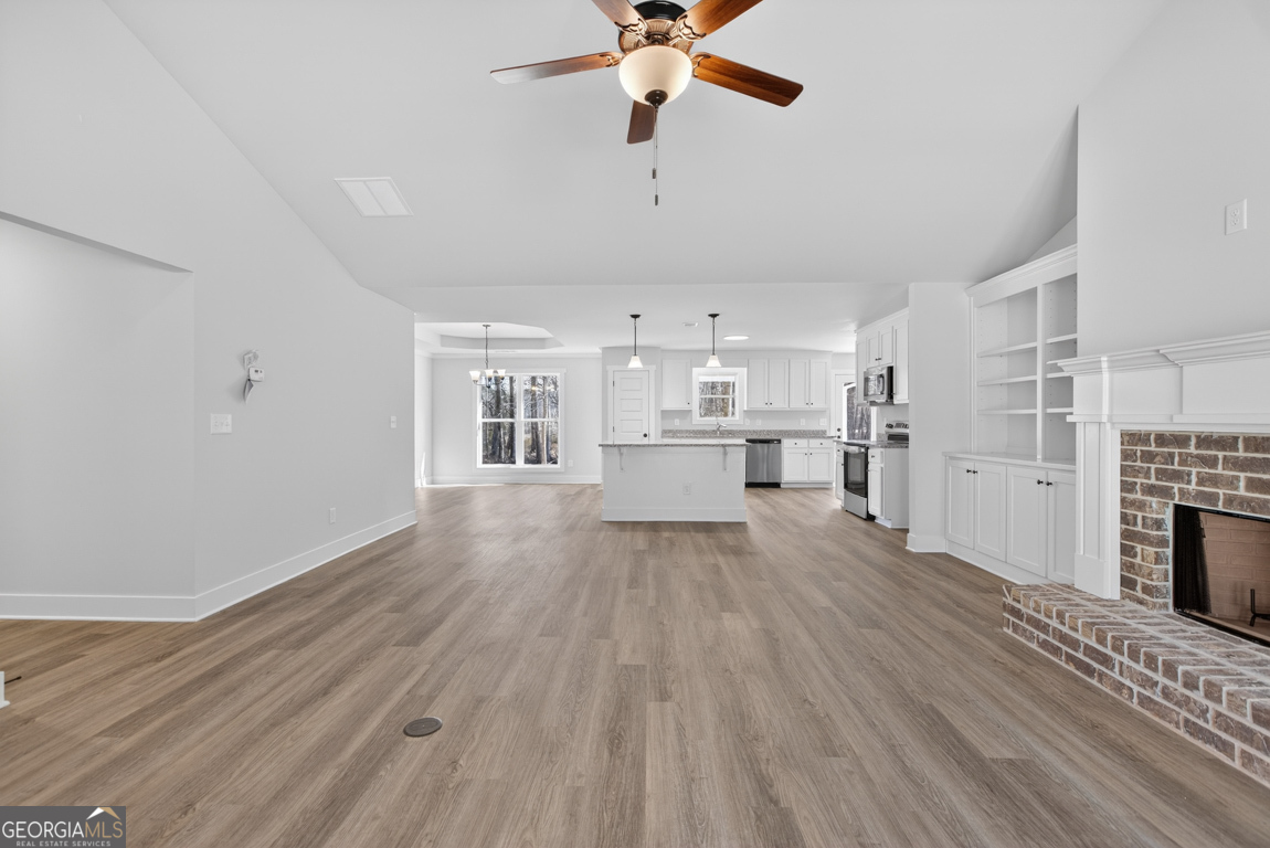 302 Mockingbird Lane, Unit 25 Winder, GA 30680 - Photo 6 of 38 a view of a kitchen with wooden floor a sink a refrigerator and window
