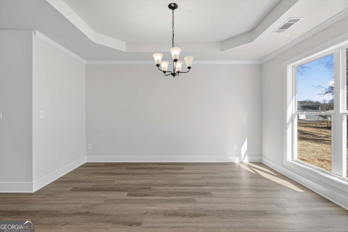 302 Mockingbird Lane, Unit 25 Winder, GA 30680 - Photo 10 of 38 a view of an empty room with wooden floor and a window