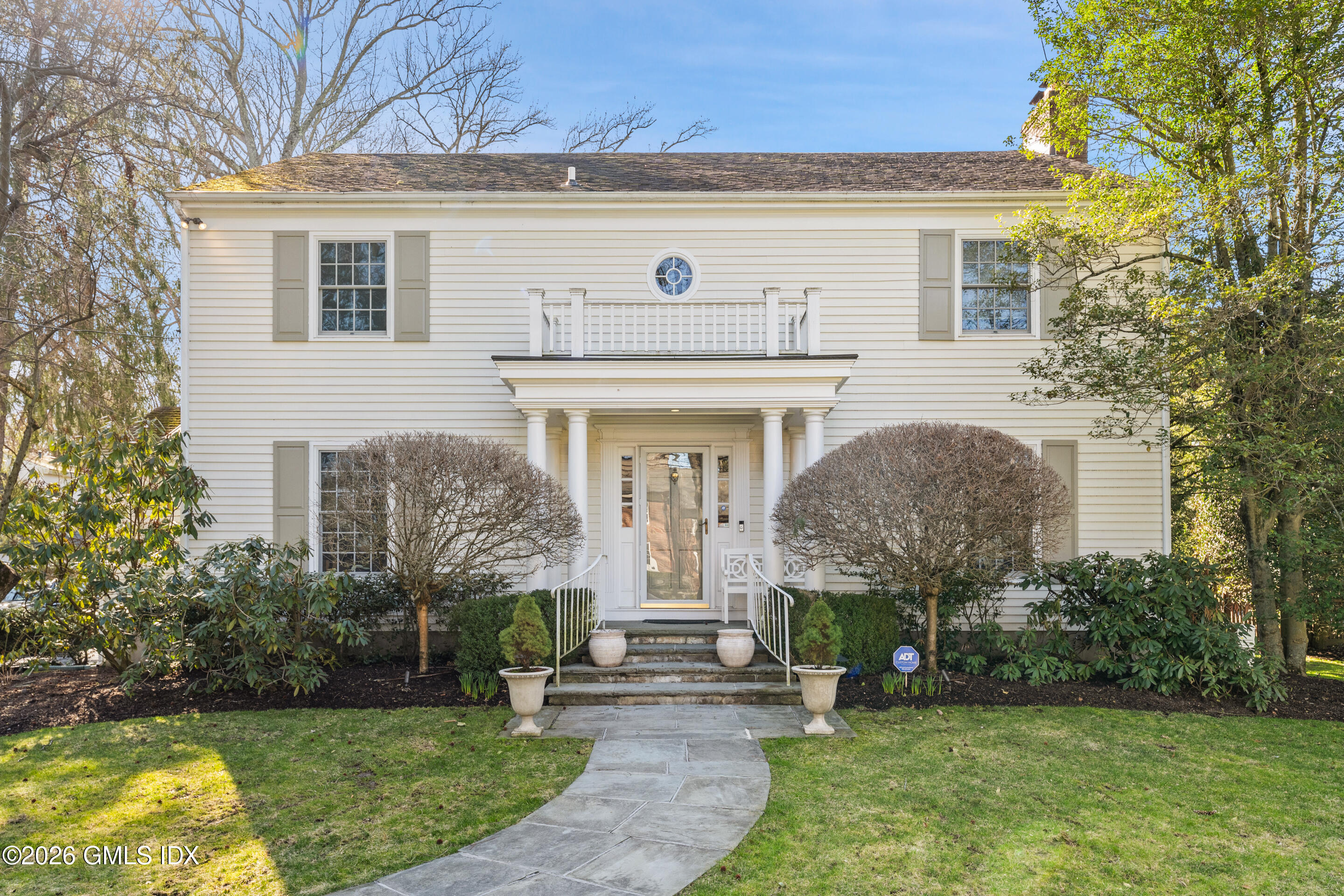 a front view of a house with garden