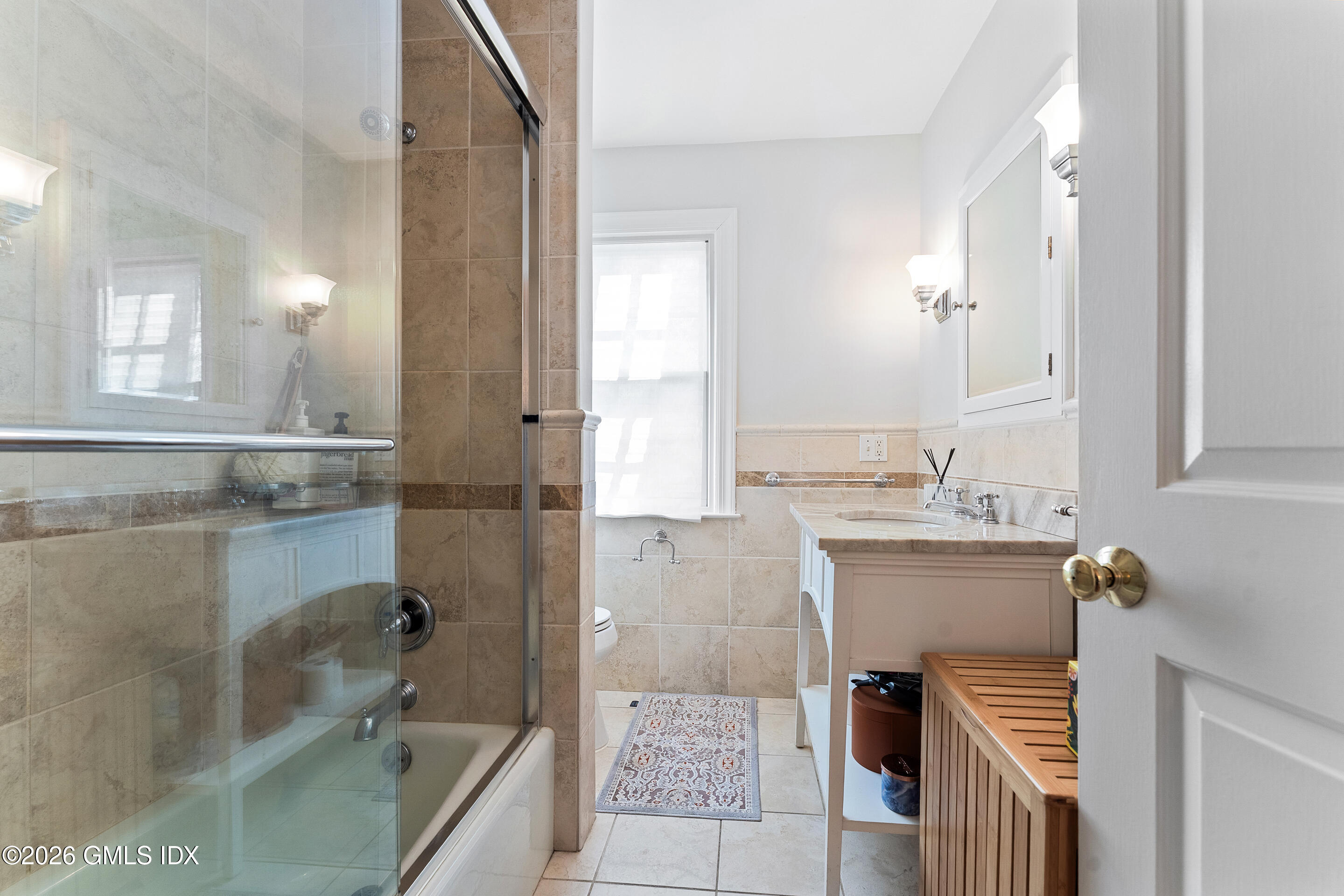 78 Meadow Road Riverside, CT 06878 - Photo 11 of 17 a bathroom with a granite countertop sink a mirror and bathtub