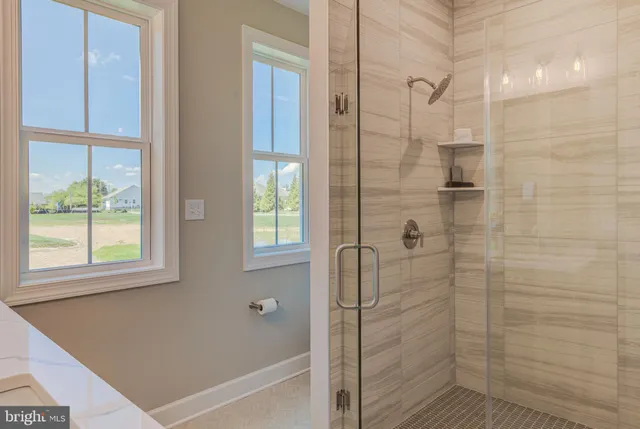 a bathroom with a bathtub and shower