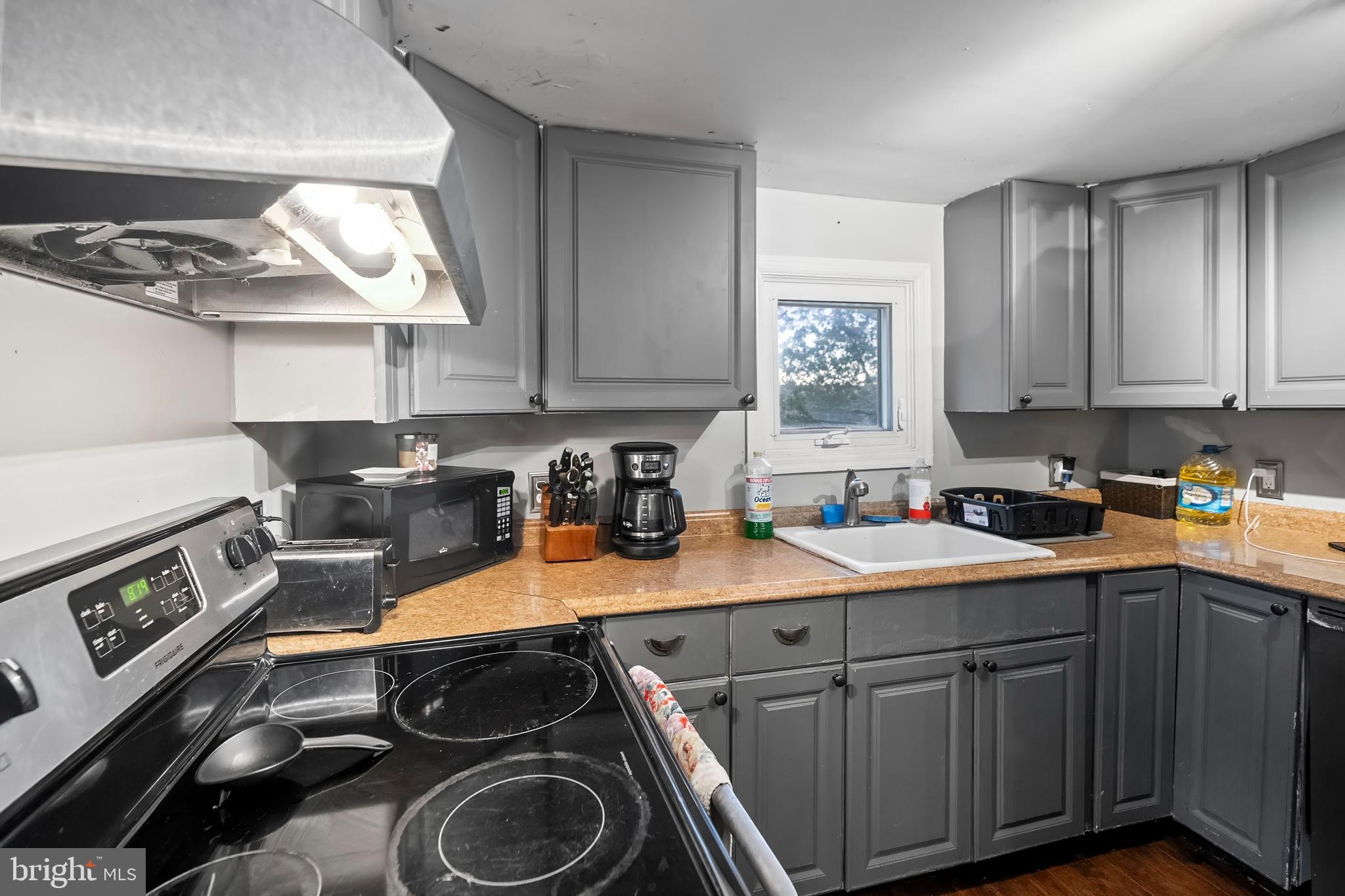 2074 Liberty Grove Road Colora, MD 21917 - Photo 6 of 21 a kitchen with a sink stove and cabinets