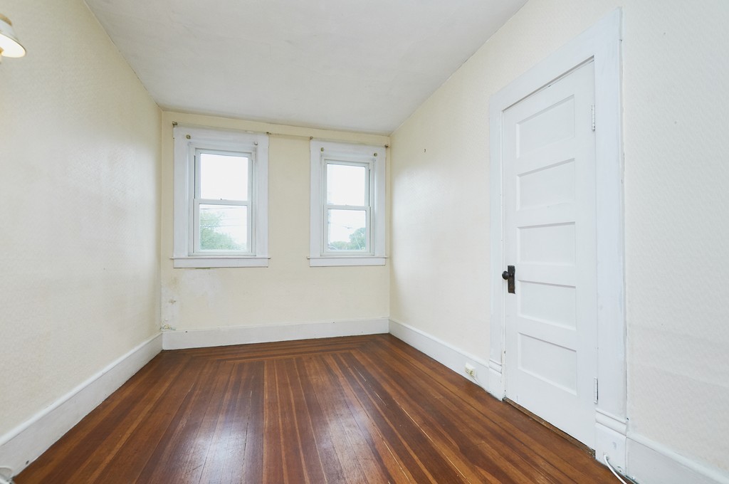 1146 Chestnut Street Newton, MA 02464 - Photo 15 of 19 an empty room with wooden floor and windows