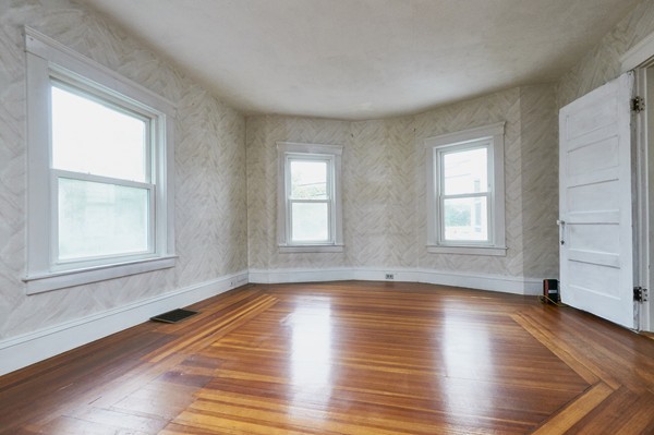 1146 Chestnut Street Newton, MA 02464 - Photo 6 of 19 an empty room with wooden floor and windows