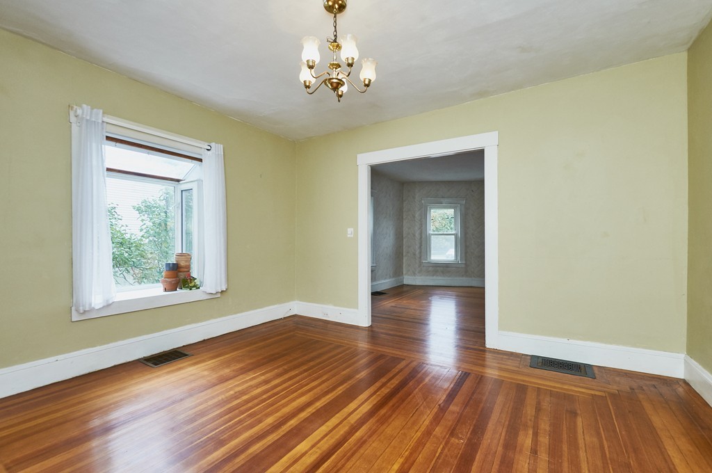 1146 Chestnut Street Newton, MA 02464 - Photo 7 of 19 a view of an empty room with wooden floor and a window